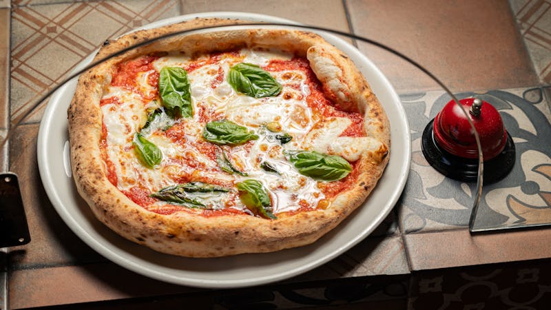 Classic Margherita pizza with fresh basil and tomato sauce